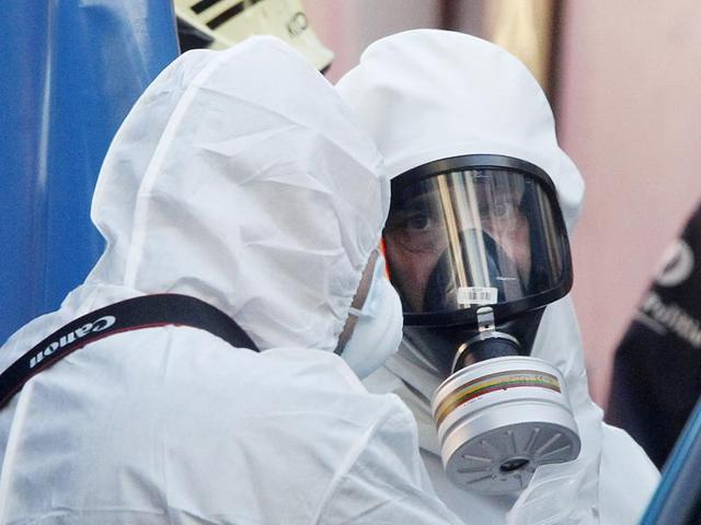 Two men in a white hazmat suits stand near the Grand Mosque of Brussels Thursday. Emergency personnel responded at the mosque after a suspicious package was found. (AP Photo) Two men in a white hazmat suits stand near the Grand Mosque of Brussels Thursday. Emergency personnel responded at the mosque after a suspicious package was found. (AP Photo)
