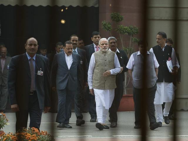 Prime Minster Narendra Modi accompanied by other ministers walk to inaugurate an exhibition on the Indian Constitution, on the opening day of the winter session of the parliament house, in New Delhi. (AP)
