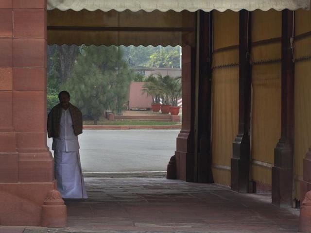 Minister for parliamentary affairs and urban development Venkaiah Naidu waits to welcome Prime Minister Narendra Modi on the opening day of the winter session of the Indian Parliament house. (AP)