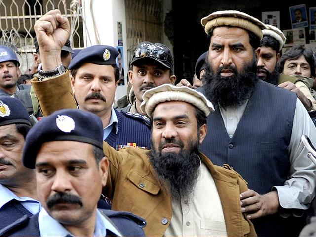 Zaki-ur-Rahman Lakhvi, the main suspect of the Mumbai terror attacks in 2008, raises his fist after his court appearance in Islamabad, Pakistan.(AP File Photo)