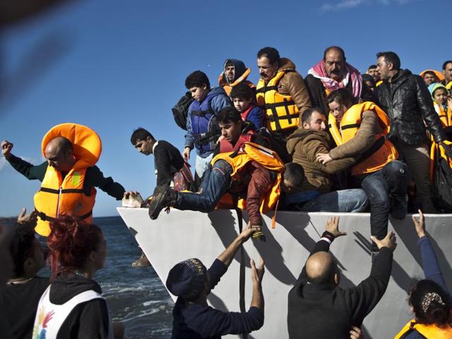 Refugees disembark from a vessel after their arrival from the Turkish coast to the northeastern Greek island of Lesbos. (AP) Refugees disembark from a vessel after their arrival from the Turkish coast to the northeastern Greek island of Lesbos. (AP)
