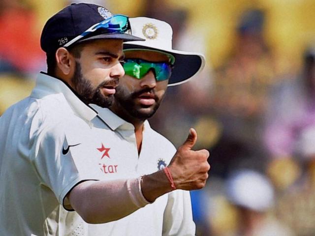 Virat Kohli and Rohit Sharma discuss field placements. (PTI Photo)