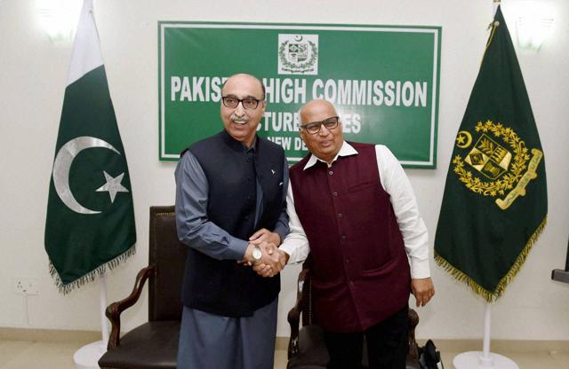 Pakistan high commissioner to India Abdul Basit shaking hand with columnist Sudheendra Kulkarni during the Pakistan high commission lecture series in New Delhi. (PTI)