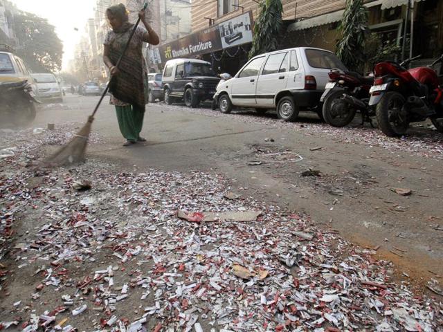 MCD workers clean a street littered with burst crackers on the morning after Diwali in Patel Nagar, New Delhi. (HT Photo/Sanchit Khanna) MCD workers clean a street littered with burst crackers on the morning after Diwali in Patel Nagar, New Delhi. (HT Photo/Sanchit Khanna)