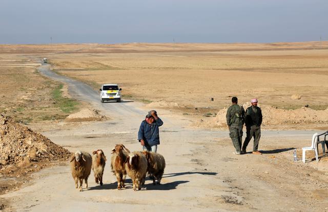 A Syrian man herds his sheep past Syrian Democratic Forces at the entrance to the Al-Shallal suburb of the northeastern town of Al-Hol in Syria's Hasakeh province after they re-took control of the area from IS jihadists. (AFP photo) A Syrian man herds his sheep past Syrian Democratic Forces at the entrance to the Al-Shallal suburb of the northeastern town of Al-Hol in Syria's Hasakeh province after they re-took control of the area from IS jihadists. (AFP photo)