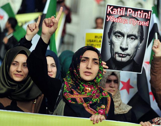 Turkish protesters shout anti-Russia slogans as they hold a poster of Russian President Vladimir Putin that reads in Turkish and Russian " Assassin Putin! " during a protest in Istanbul. (AP) Turkish protesters shout anti-Russia slogans as they hold a poster of Russian President Vladimir Putin that reads in Turkish and Russian " Assassin Putin! " during a protest in Istanbul. (AP)