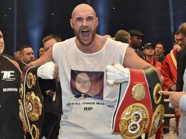 Britain's new world champion Tyson Fury celebrates with the WBA, IBF, WBO and IBO belts after winning the world heavyweight title fight against Ukraine's Wladimir Klitschko in the Esprit Arena in Duesseldorf, western Germany. (AP) Britain's new world champion Tyson Fury celebrates with the WBA, IBF, WBO and IBO belts after winning the world heavyweight title fight against Ukraine's Wladimir Klitschko in the Esprit Arena in Duesseldorf, western Germany. (AP)