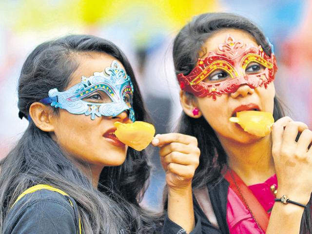 Girls enjoy some ice-cream during the Chandigarh Carnival being held at the Leisure Valley. (Keshav singh/HT Photo)