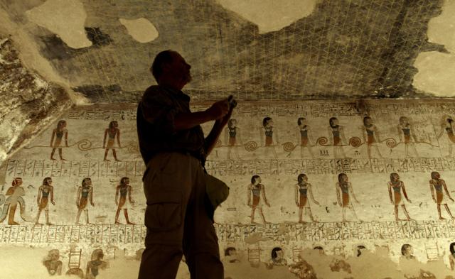 A tourist takes photos of inscriptions on the walls of King Merenptah's tomb in the Valley of the Kings in Luxor, Egypt. The hidden chamber might belong to Queen Nefertiti. (AP Photo) A tourist takes photos of inscriptions on the walls of King Merenptah's tomb in the Valley of the Kings in Luxor, Egypt. The hidden chamber might belong to Queen Nefertiti. (AP Photo)