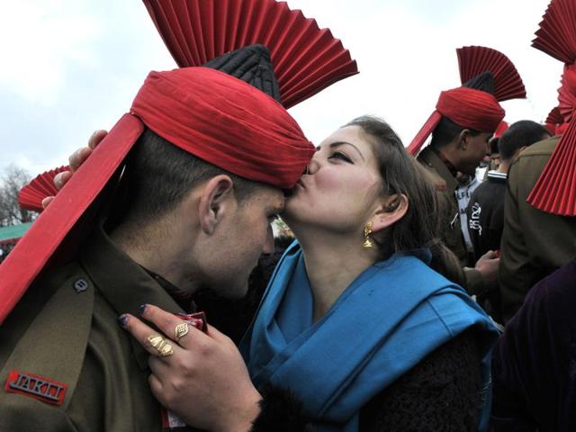A new recruit’s relative kisses him after the passing out parade at an army base on the outskirts of Srinagar. (Waseem Andrabi/HT Photo)