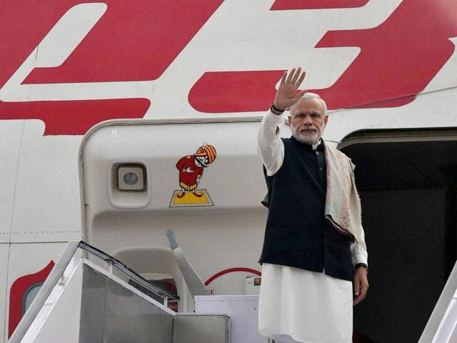 Prime Minister Narendra Modi waves before his departure for France to attend the Paris Climate Conference, at AFS Palam in New Delhi on Saturday.(PTI Photo) Prime Minister Narendra Modi waves before his departure for France to attend the Paris Climate Conference, at AFS Palam in New Delhi on Saturday.(PTI Photo)