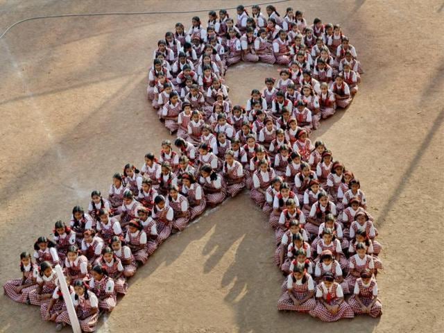 School girls make a human chain in the shape of AIDS symbol to create awareness on the eve of 'World Aids day'. (PTI) School girls make a human chain in the shape of AIDS symbol to create awareness on the eve of 'World Aids day'. (PTI)