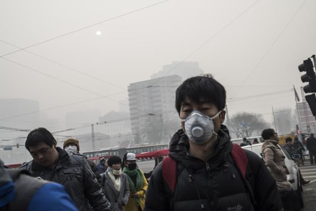 Pedestrians wear masks on a polluted day in Beijing on November 30, 2015. Beijing choked under the worst smog of the year on November 30, with dangerous particulates nearly 20 times healthy levels, as China's president joined other leaders in Paris for key climate change talks. (AFP) Pedestrians wear masks on a polluted day in Beijing on November 30, 2015. Beijing choked under the worst smog of the year on November 30, with dangerous particulates nearly 20 times healthy levels, as China's president joined other leaders in Paris for key climate change talks. (AFP)