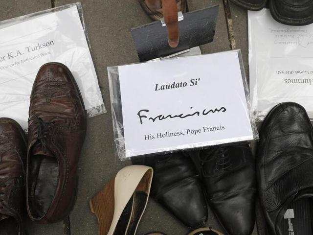Pope Francis' shoes are seen in the middle of hundreds of pairs of shoes displayed at the Place de la Republique, in Paris, as part of a symbolic and peaceful rally called by the NGO Avaaz after French police detained hundreds of protesters and banned demonstrations, citing security issues after the November 13 terrorist attacks. (AP Photo) Pope Francis' shoes are seen in the middle of hundreds of pairs of shoes displayed at the Place de la Republique, in Paris, as part of a symbolic and peaceful rally called by the NGO Avaaz after French police detained hundreds of protesters and banned demonstrations, citing security issues after the November 13 terrorist attacks. (AP Photo)