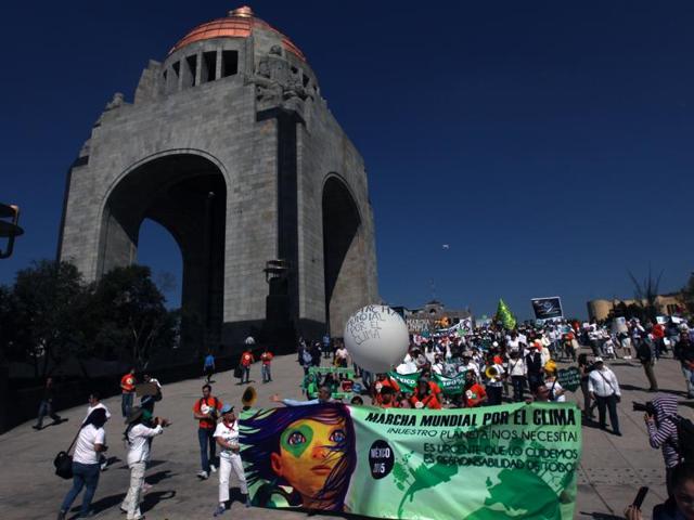 People march during a protest for Global Climate next to a monument to the Revolution, in Mexico City. (AP Photo) People march during a protest for Global Climate next to a monument to the Revolution, in Mexico City. (AP Photo)