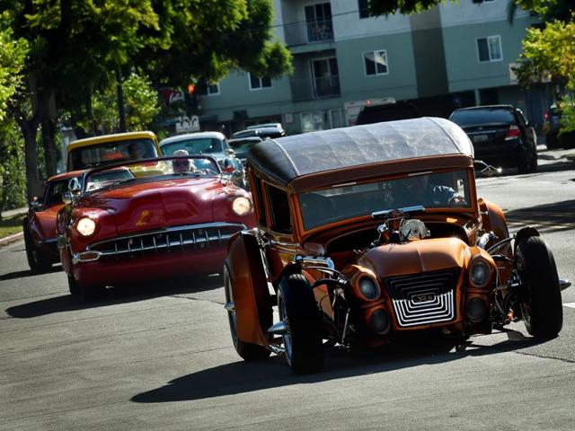 Mourners in hot rods and custom cars arrive for the funeral service of legendary Hollywood film and television car builder George Barris. His casket was inspired by his most famous creation, Batmobile. (AFP)