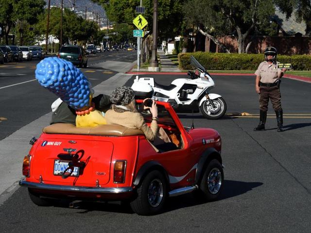 Mourners in a custom car arrive for the funeral service of legendary Hollywood film and television car builder George Barris. He was a custom car maker best known for designing and building the Batmobile made famous in the mid-1960s. (AFP)