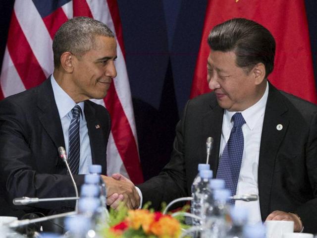 US President Barack Obama, left, shakes hands with Chinese President Xi Jinping during their meeting held on the sidelines of the COP21, United Nations Climate Change Conference in Le Bourget outside Paris on Monday. (AP) US President Barack Obama, left, shakes hands with Chinese President Xi Jinping during their meeting held on the sidelines of the COP21, United Nations Climate Change Conference in Le Bourget outside Paris on Monday. (AP)