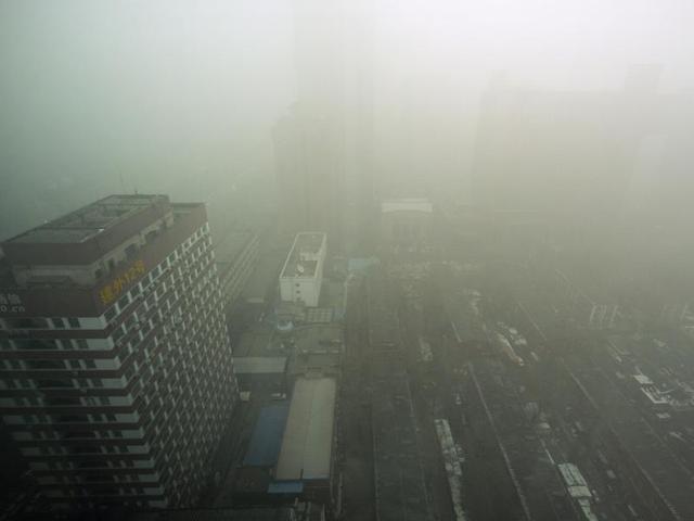 Fog and heavy pollution shroud a neighbourhood in Beijing. Schools in Beijing were ordered to keep students indoors Tuesday after record-breaking air pollution in the Chinese capital soared to up to 35 times the safety levels. (AP Photo)