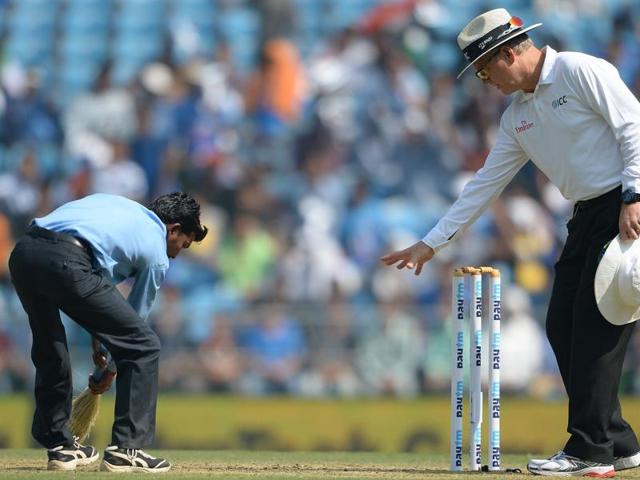 Umpire Bruce Oxenford (R) instructs a member of the groundstaff to sweep dust off the pitch during play on the first day of the third Test cricket match between India and South Africa at The Vidarbha Cricket Association Stadium in Nagpur. (AFP) Umpire Bruce Oxenford (R) instructs a member of the groundstaff to sweep dust off the pitch during play on the first day of the third Test cricket match between India and South Africa at The Vidarbha Cricket Association Stadium in Nagpur. (AFP)