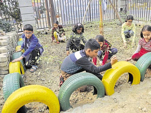 Children are using tyres instead of flower pots to grow plants in the garden at the Shipra Krishna Vista Apartments. (Sakib Ali/HT Photo) Children are using tyres instead of flower pots to grow plants in the garden at the Shipra Krishna Vista Apartments. (Sakib Ali/HT Photo)