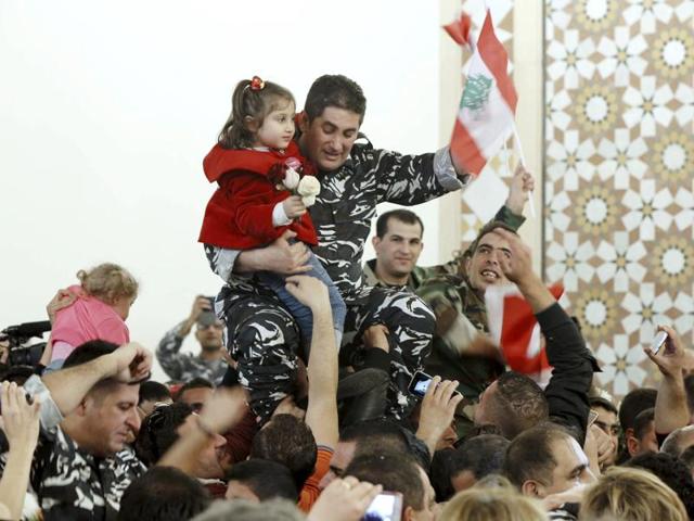 A Lebanese soldier helps a fellow member of the security forces, who has been released by the Nusra Front.(AFP)