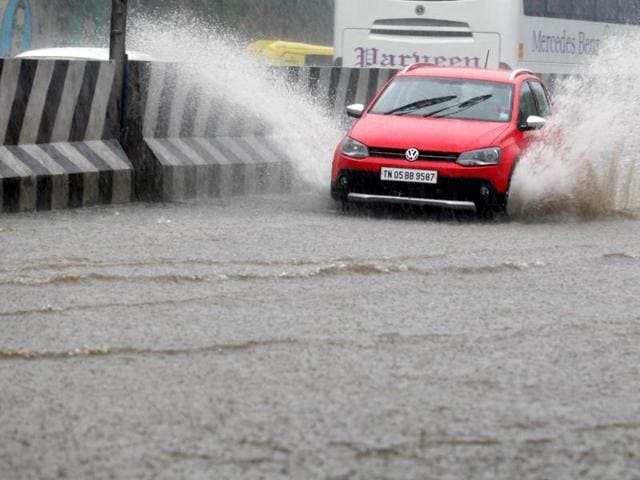 Vehicles wade through a water logged road following heavy rains in Chennai. (HT Photo)