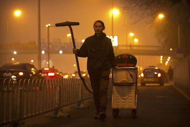 Chinese artist Wang Renzheng demonstrates the use of his industrial shop-vac alongside a highway in Beijing. (AP Photo) Chinese artist Wang Renzheng demonstrates the use of his industrial shop-vac alongside a highway in Beijing. (AP Photo)