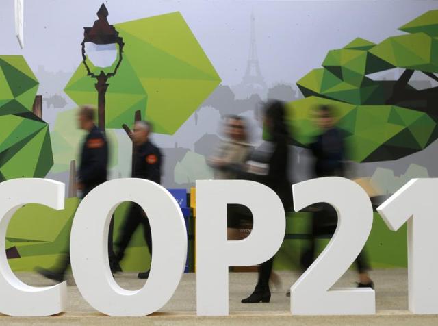 People walk past the COP21 logo in the Climate Generations area during the World Climate Change Conference 2015 (COP21) at Le Bourget, near Paris. (Reuters Photo) People walk past the COP21 logo in the Climate Generations area during the World Climate Change Conference 2015 (COP21) at Le Bourget, near Paris. (Reuters Photo)