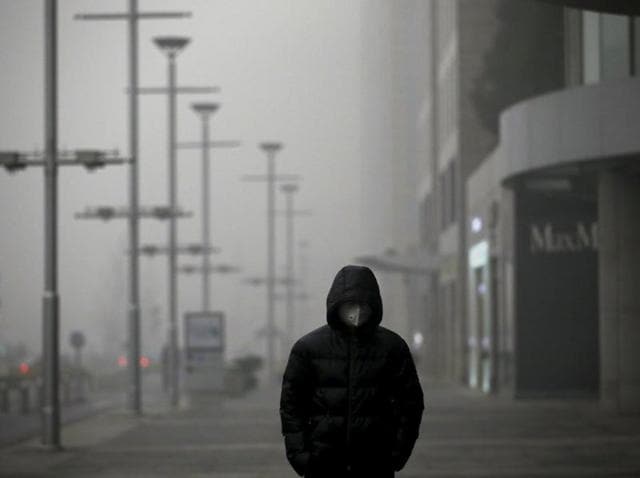 A man wearing a protective mask walks as smog covers China's capital Beijing. (REUTERS) A man wearing a protective mask walks as smog covers China's capital Beijing. (REUTERS)