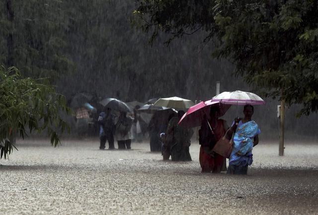 Staffs and visitors make their way from a flooded Government hospital during heavy rains in Chennai. (PTI) Staffs and visitors make their way from a flooded Government hospital during heavy rains in Chennai. (PTI)
