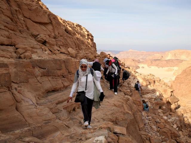 Hikers walk to reach the top of Naqba Rum area in South Sinai, Egypt, November 20, 2015. Bedouins in the Sinai is Safe group guided more than 100 hikers over a 25 km (15 mile) trek over the trails of the White Canyon and the Closed Canyon.   (REUTERS) 