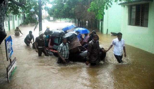 Rescue workers and volunteers use an inflatable boat to take residents through floodwaters in Chennai. (AFP) Rescue workers and volunteers use an inflatable boat to take residents through floodwaters in Chennai. (AFP)