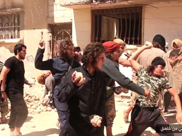 In this picture posted on a social media account affiliated with the Islamic State group, IS militants stone a man accused of violating the extremists' ban on homosexuality after they threw him from a roof in the city of Homs, Syria. (AP Photo) In this picture posted on a social media account affiliated with the Islamic State group, IS militants stone a man accused of violating the extremists' ban on homosexuality after they threw him from a roof in the city of Homs, Syria. (AP Photo)