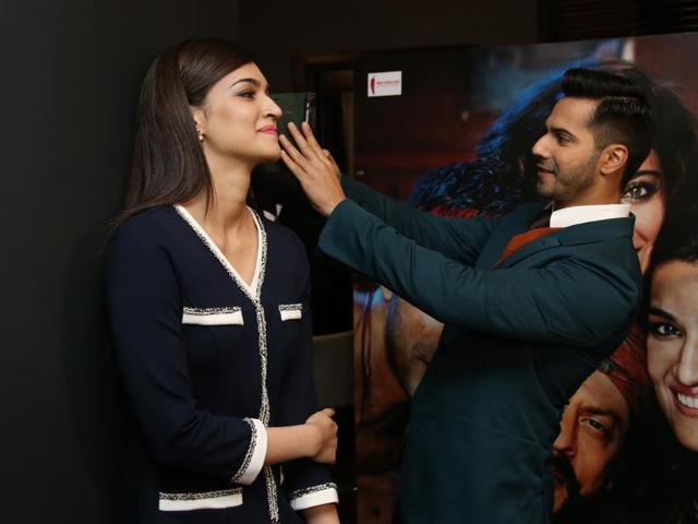 Varun Dhawan takes a selfie as Kriti Sanon looks on in London on December 1, 2015. (AP)