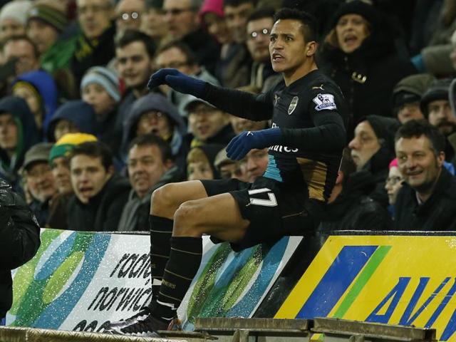 Arsenal’s Alexis Sanchez after falling into the TV pit  during their match against Norwich City. (Reuters)