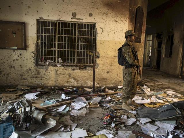 A man places a rose after lighting candles in front of portraits of the victims of the Taliban attack on the Army Public School in Peshawar, during a candlelight vigil in Lahore in this December 19, 2014 file photo. Pakistan executed four men on December 2, 2015 for involvement in the massacre of 134 children at the school. (REUTERS) A man places a rose after lighting candles in front of portraits of the victims of the Taliban attack on the Army Public School in Peshawar, during a candlelight vigil in Lahore in this December 19, 2014 file photo. Pakistan executed four men on December 2, 2015 for involvement in the massacre of 134 children at the school. (REUTERS)