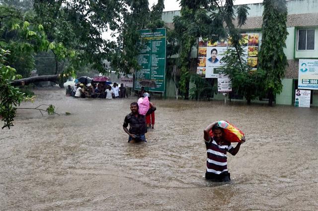 People shift from a flooded hospital after heavy rains in Chennai. (PTI) People shift from a flooded hospital after heavy rains in Chennai. (PTI)