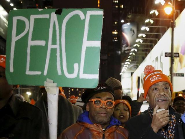 Reverend Al Sharpton (R) and Spike Lee (C) march to Times Square after the premiere of Chi-Raq . (REUTERS)