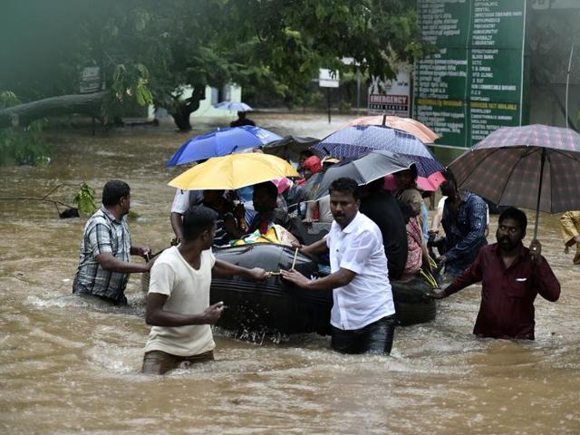 Patients and their care-takers are being shifted to safer places from a flooded hospital in Chennai.(HT Photo) Patients and their care-takers are being shifted to safer places from a flooded hospital in Chennai.(HT Photo)