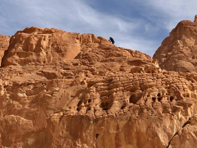 Sinai is Safe, an Egyptian NGO, is running a grassroots hiking campaign that aims to change the image of Sinai--specifically South Sinai--as a danger zone it is often made out to be. It aims to revive tourism that is so important to its local Bedouin communities. A hiker climbs a rocky area at the Closed Canyon in South Sinai, Egypt, November 21, 2015.   (REUTERS) 