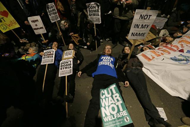 Protesters against Britain launching airstrikes against the Islamic State group inside Syria, lie down during a demonstration outside the Houses of Parliament, in London. (AP) Protesters against Britain launching airstrikes against the Islamic State group inside Syria, lie down during a demonstration outside the Houses of Parliament, in London. (AP)