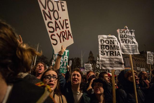 Anti-war protesters react after learning the outcome of the British government's vote on military action against the Islamic State (IS) group in Syria, during a protest outside the Houses of Parliament in central London. (AFP) Anti-war protesters react after learning the outcome of the British government's vote on military action against the Islamic State (IS) group in Syria, during a protest outside the Houses of Parliament in central London. (AFP)