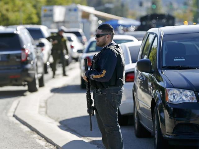 People are evacuated by law enforcement agencies from the Inland Regional Center which was the scene of a shooting in San Bernardino, California. (AP Photo)