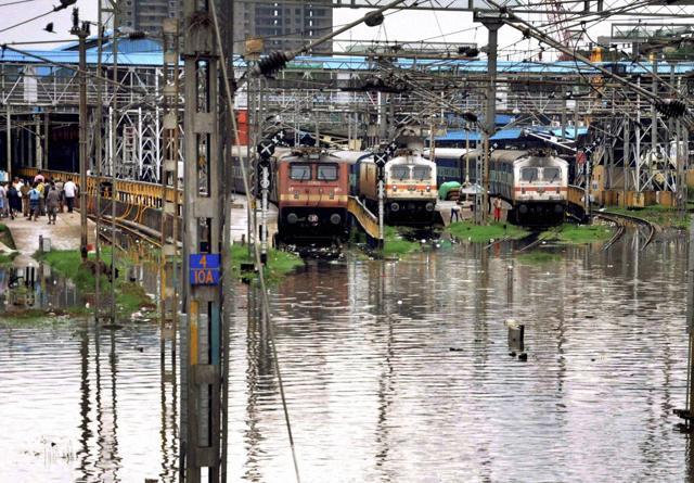 Trains stand stranded at a railway station near flooded tracks after heavy rains in Chennai on Wednesday. (PTI) Trains stand stranded at a railway station near flooded tracks after heavy rains in Chennai on Wednesday. (PTI)
