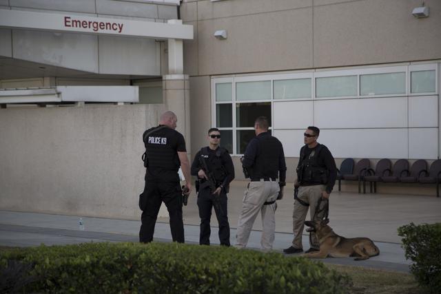 Police officers guard the emergency entrance at Arrowhead Regional Medical Center where numerous victims of a mass shooting were admitted. (AFP) Police officers guard the emergency entrance at Arrowhead Regional Medical Center where numerous victims of a mass shooting were admitted. (AFP)