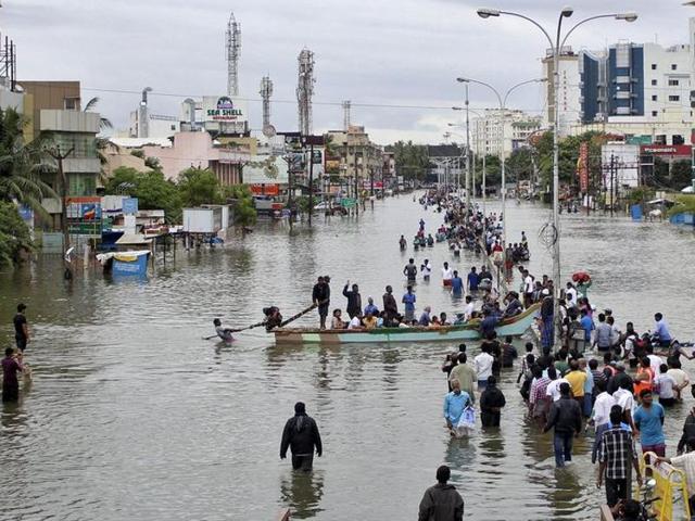 People travel on a boat as they move to safer places through a flooded road in Chennai. (Reuters Photo)