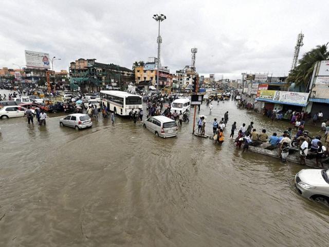 Vehicles move on the waterlogged road during heavy rains in Chennai on Wednesday. (PTI )