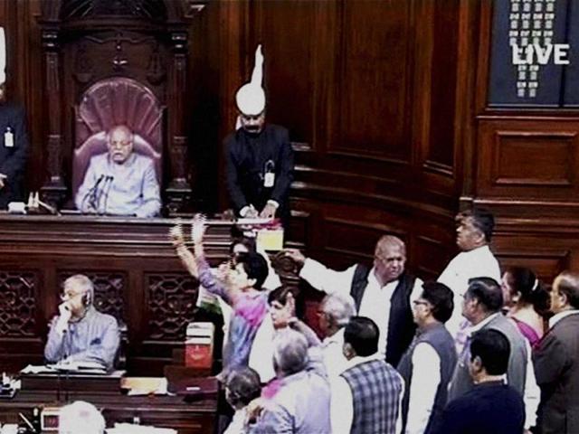 Opposition members protest in Rajya Sabha during the winter session of Parliament, in New Delhi . (PTI Photo) Opposition members protest in Rajya Sabha during the winter session of Parliament, in New Delhi . (PTI Photo)