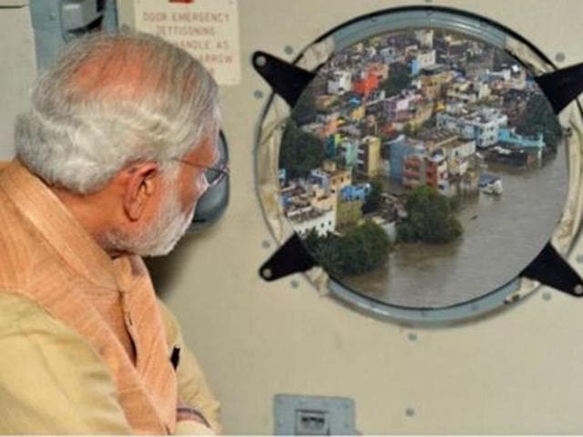 PIB released a photo showing PM Narendra Modi looking outside of an aircraft window to scenery that had been merged from another photograph.(Twitter @PIBIndia)
